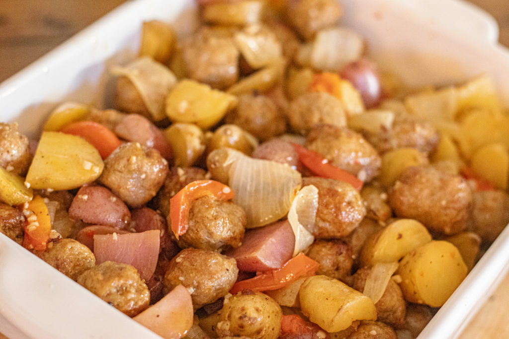 Closeup of a potato, sausage, onion and red pepper casserole.