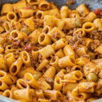 Beef Picadillo Ragu sitting in the pan it was cooked in. This dish is made with mezze rigatoni which is the smaller size rigatoni.