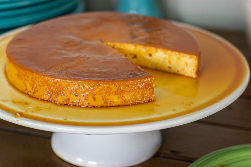 Flan de Leche Dominican style. One slice is missing showing you the inside texture as well.