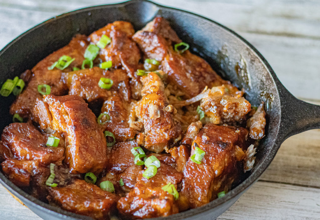 4 Ingredient Instant Pot BBQ Ribs in a skillet topped with chopped green onions.