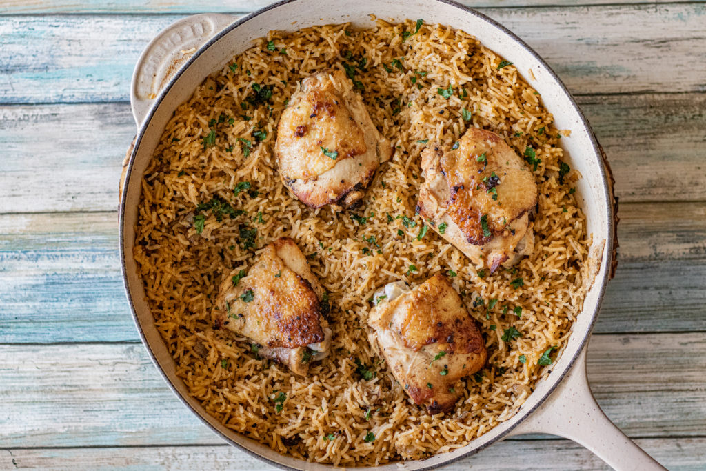 One Pot Peri Peri Chicken and Rice shot from above. The dish is still sitting in it's dutch oven which is perfect for serving as it looks absolutely beautiful in presentation. This one was made with 4 chicken thighs.