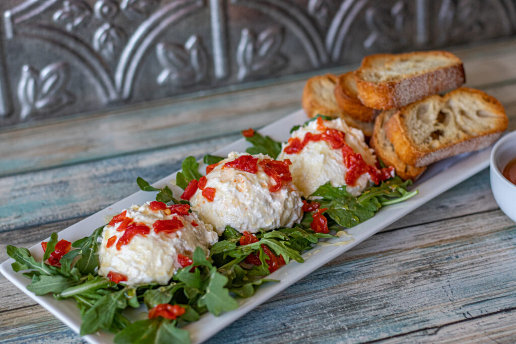 Sweet and Spicy Whipped Feta. Sweet, salty and velvety rich, this Whipped Feta is the perfect appetizer. Served with toasted ciabatta, arugula, and drizzled with honey.