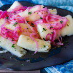 Yuca con Mojo is yuca root, boiled and served with a red onion relish that is very traditional in Caribbean islands like Dominican Republic, Cuba and Puerto Rico.