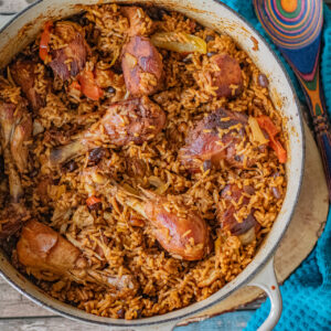 Over the top shot of a cooking pan with moro locrio in it. Moro and locrio are two different dominican dishes that I combined into one. Moro is rice with black beans and locrio is a chicken and rice dish. Beautifully seasoned and with a golden color.