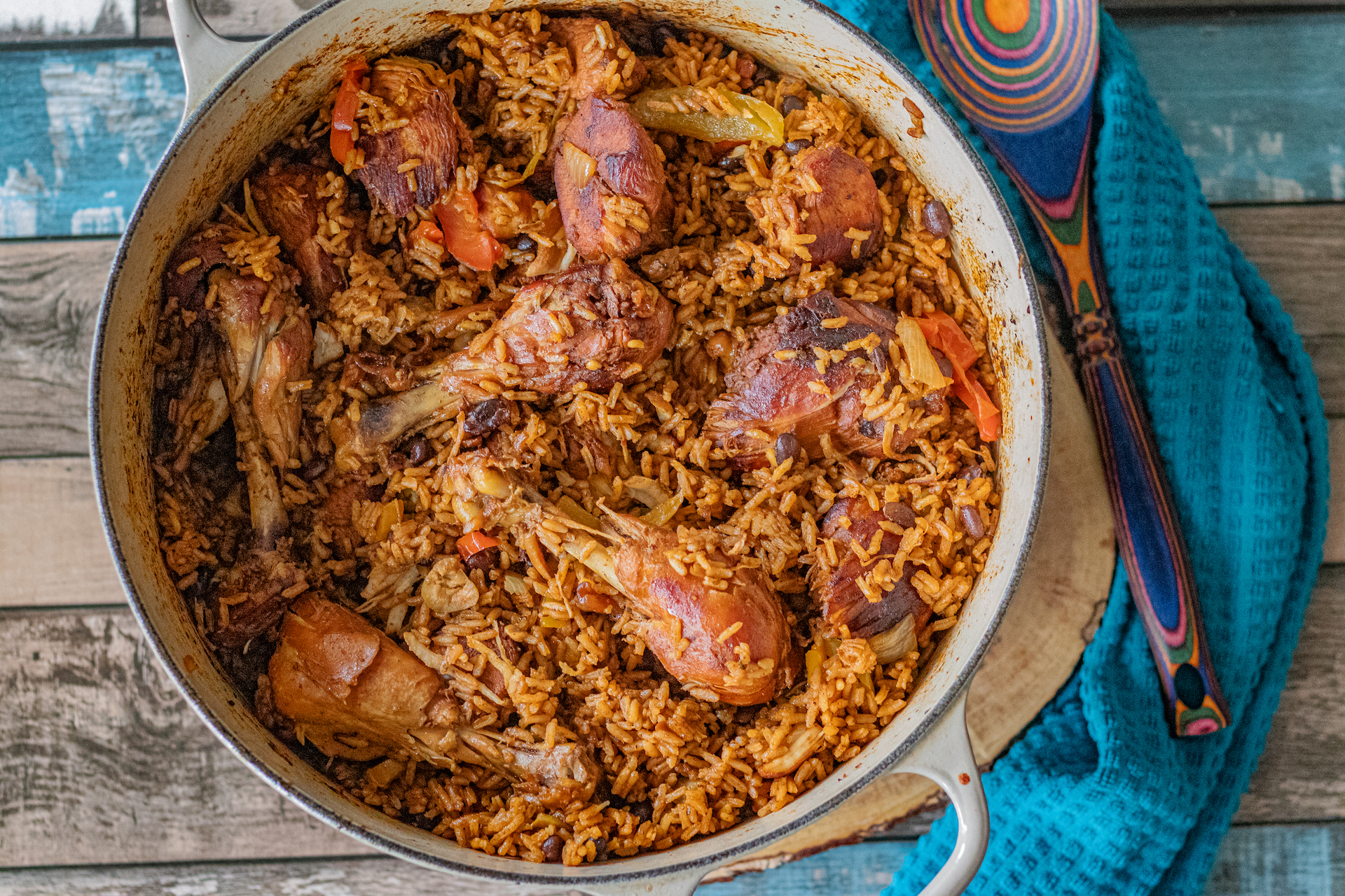 Over the top shot of a cooking pan with moro locrio in it. Moro and locrio are two different dominican dishes that I combined into one. Moro is rice with black beans and locrio is a chicken and rice dish. Beautifully seasoned and with a golden color.