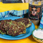 Spanglish Asadero Surf & Turf seasoning next to a small plate with cheesy broccoli fritters. Also a parmesan aioli for dipping.