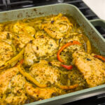 Quick Sofrito Chicken Bake. Chicken breasts chunks marinated in sofrito, and other ingredients. Placed on a baking dish and cooking in the oven for under 1 hour. Here the chicken is cooked and in the baking dish.