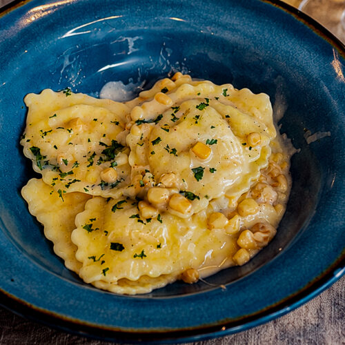 20 minute creamy corn sausage ravioli in a serving plate for one person.