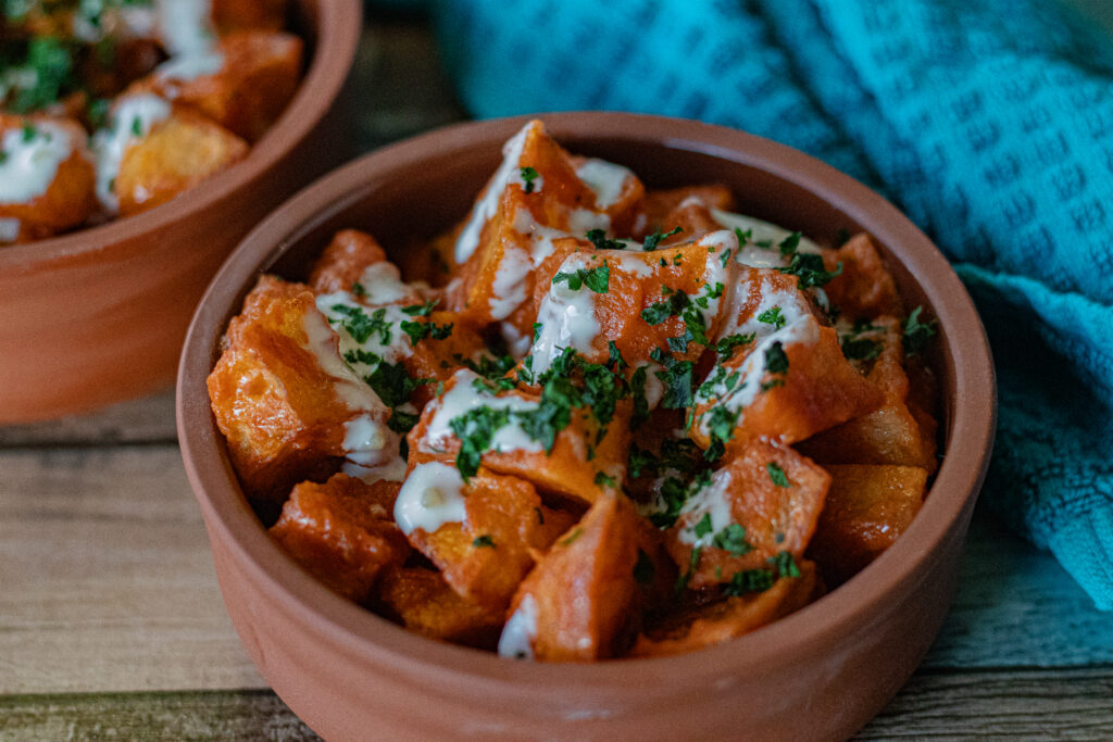 Easy Spanish Patatas Bravas with Garlic Aioli in a single serving bowl in a very tight close up