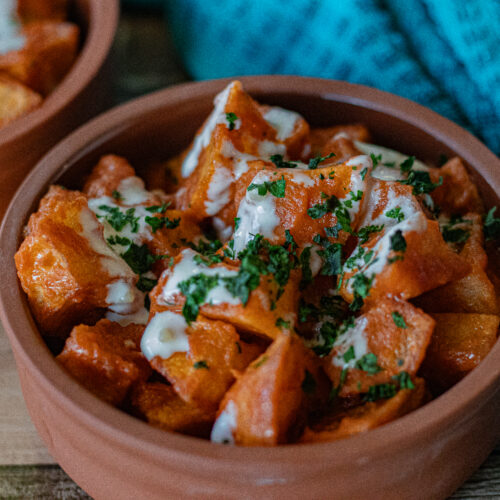 Easy Spanish Patatas Bravas with Garlic Aioli in a single serving bowl in a very tight close up